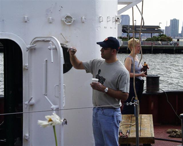 Eric Weisler gives the fireboat John J. Harvey a coat of paint.