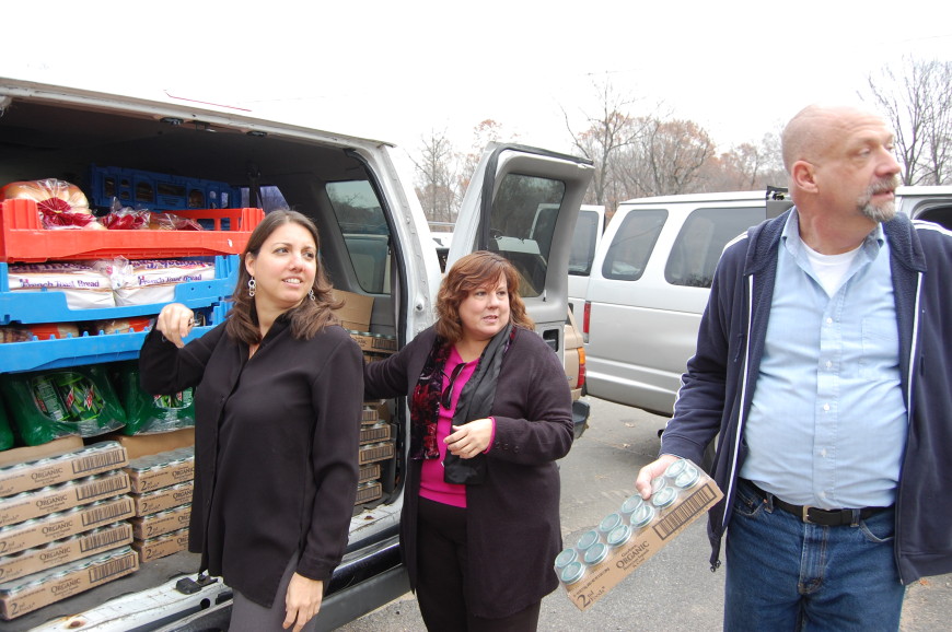 Maria Dowlng, CEO of Rockland Jewish Family Service, left, works with Diane Serratore, executive director of People to People, and Rob Mauer, executive director of TOUCH, at a food pickup for Rockland County food pantries coordinated by RJFS. 