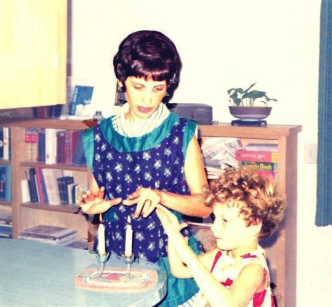 The author, Marla Cohen, lights Shabbat candles with her mother, Miriam in the late 60s. 